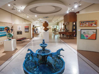 Interior photo of Midwest Museum of American Art in downtown Elkhart featuring sculptures and artwork on the wall