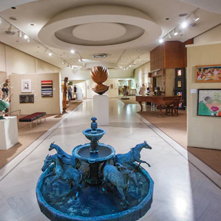 Interior photo of Midwest Museum of American Art in downtown Elkhart featuring sculptures and artwork on the wall