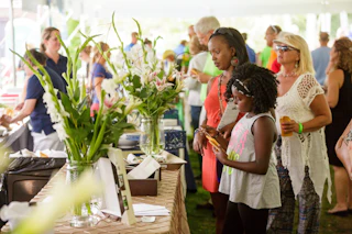 Attendees viewing food and floral displays at the Taste of the Gardens event at Wellfield Botanic Gardens in Elkhart.