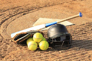 softball, tennis balls, glove, and bat on ground