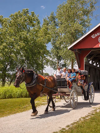 People riding on the Essenhaus carriage in Middlebury, Indiana